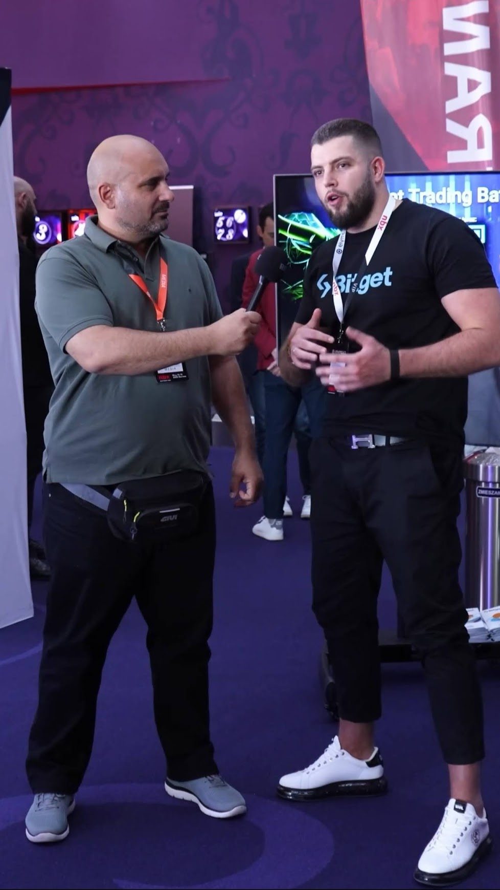 Igor Haleta in conversation with a crypto media journalist at the Bitget booth