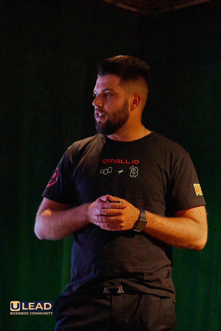 Igor Haleta giving a talk for the ULead Business Community wearing a Qmall.io t-shirt